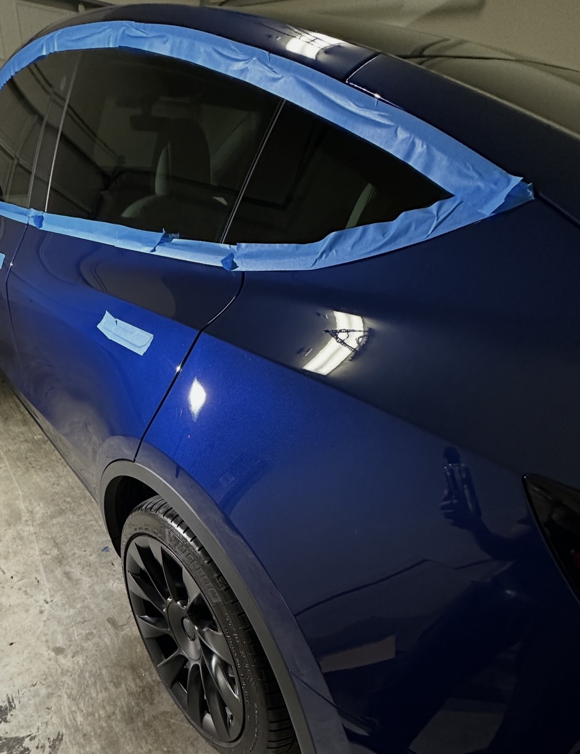 Deep blue Tesla prepped for ceramic coating
